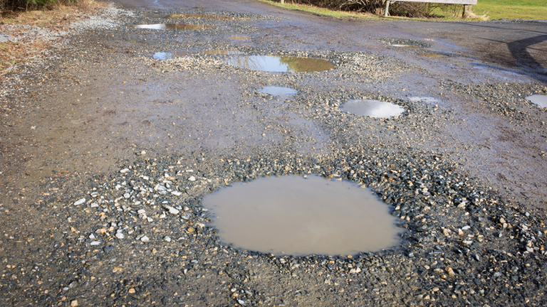 a hole filled with water in a pavement